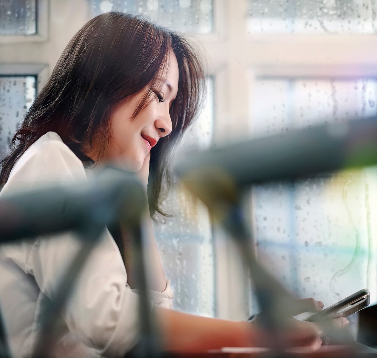 Woman asking questions on phone about gutters on rainy day
