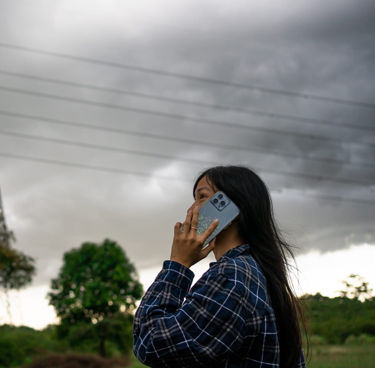 Woman on phone as a storm approaches