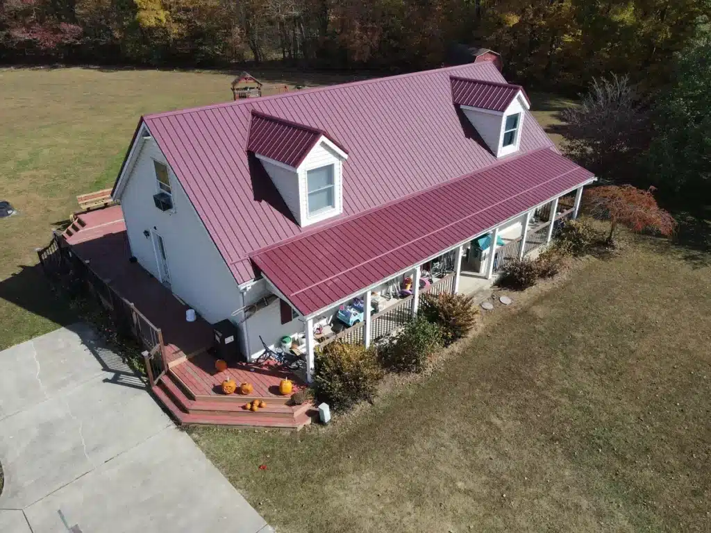 side view of red standing seam metal roof installed by roof x