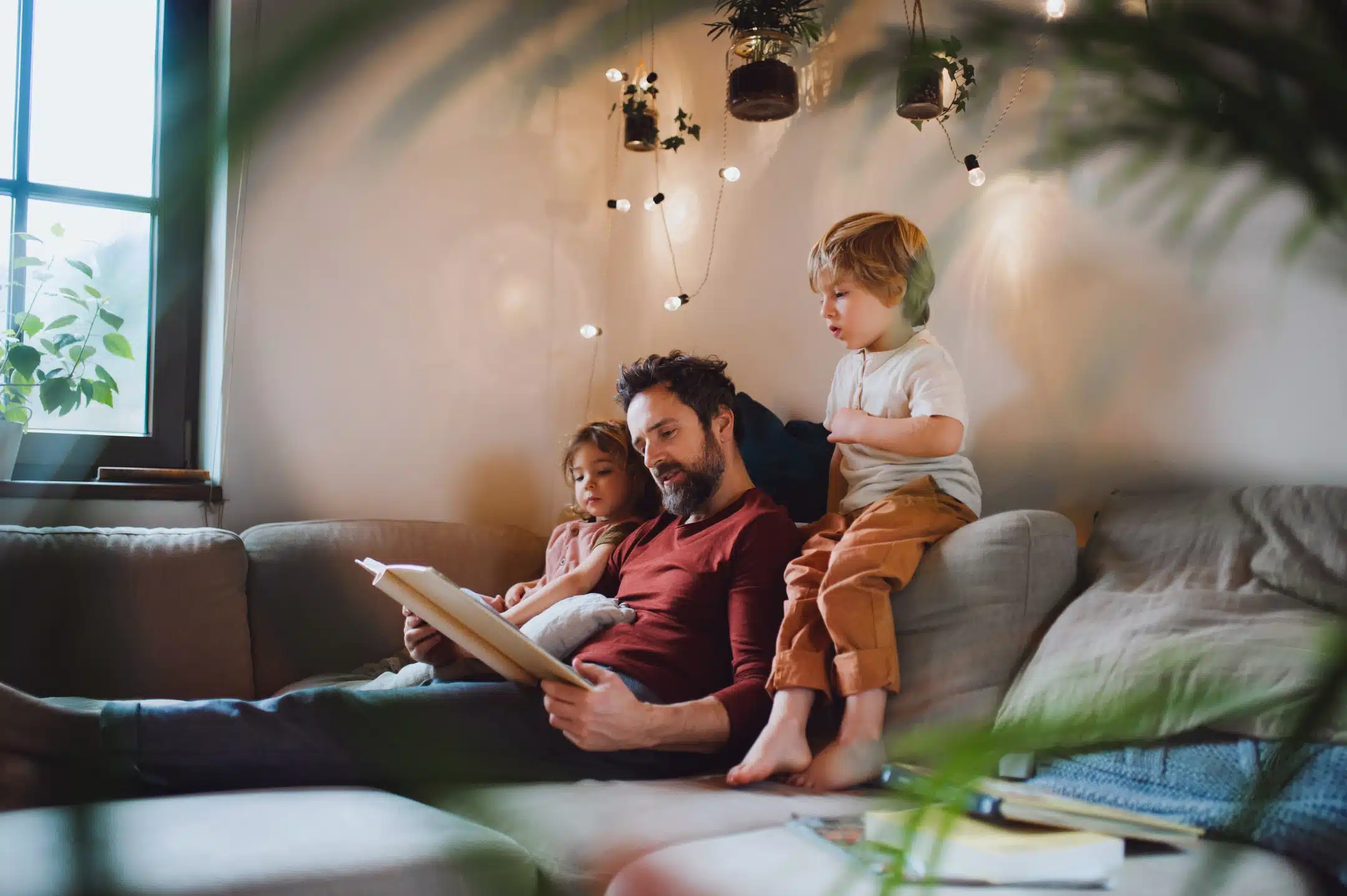 father reading to children at home