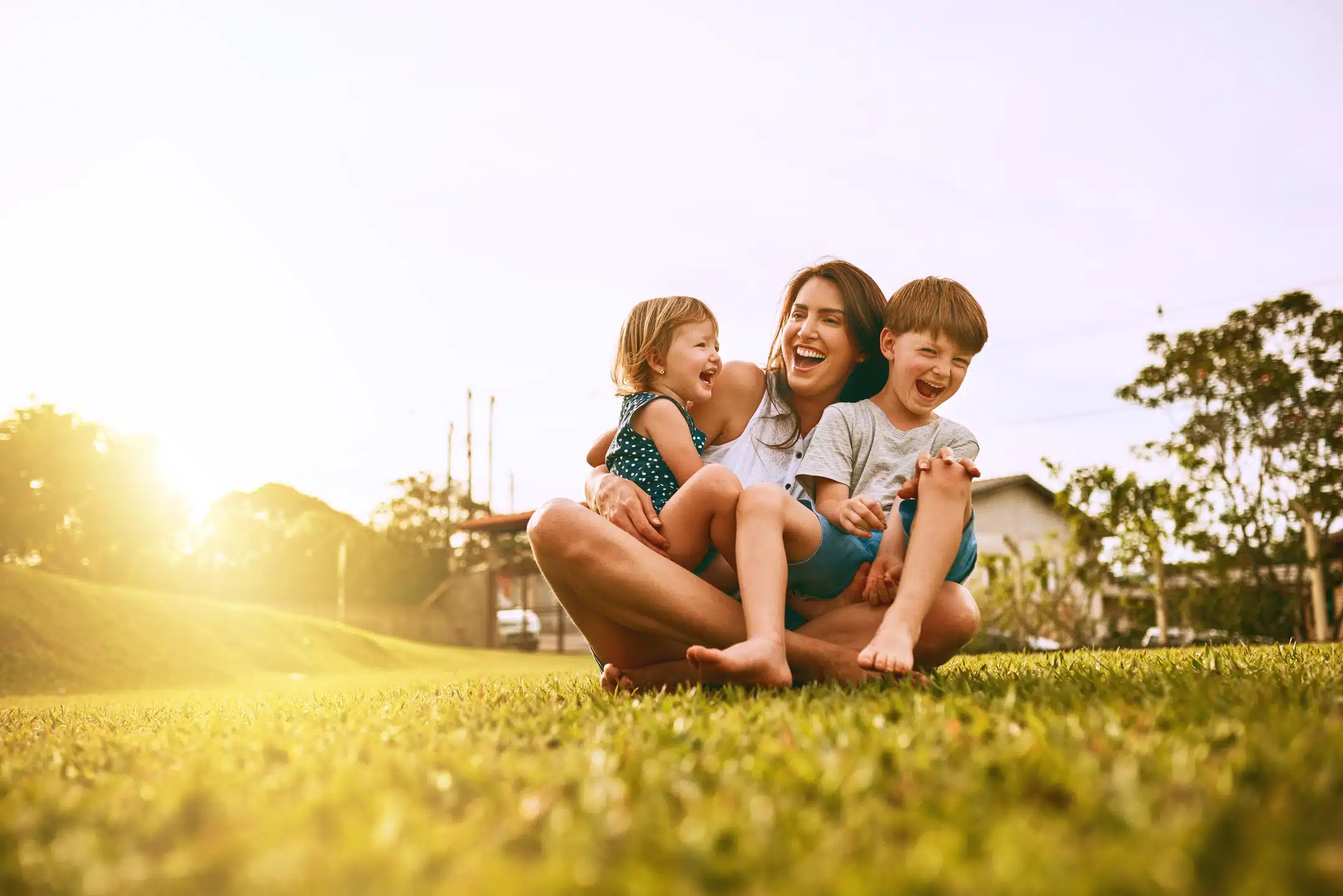 happy family playing on yard outside rural home