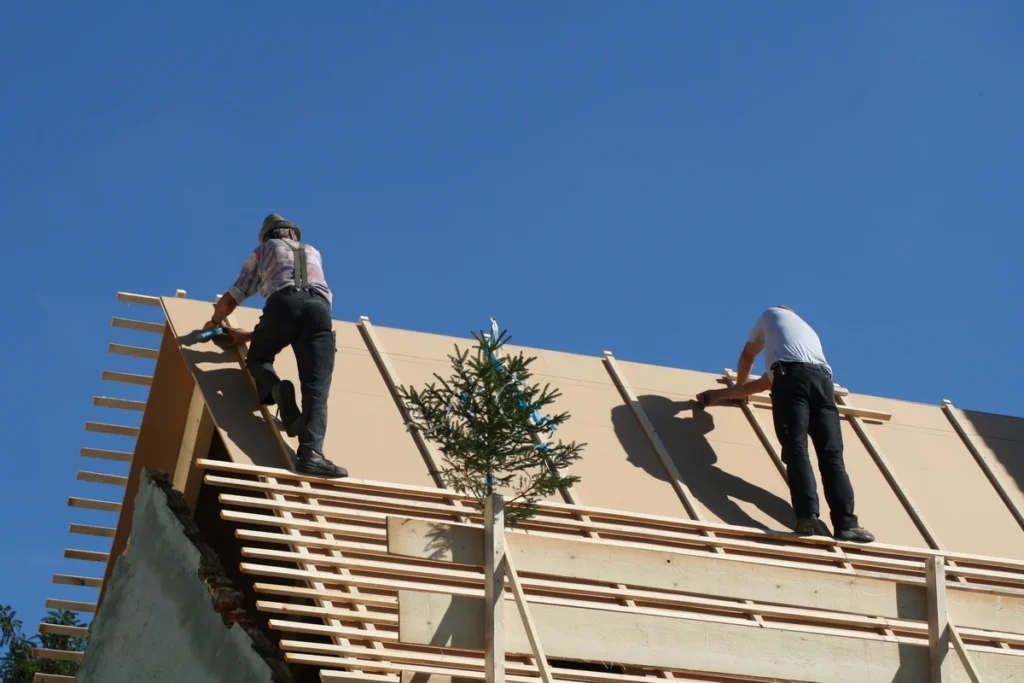 construction workers on the house roof