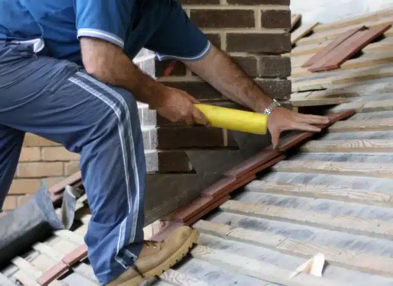 worker repairing the roof flashing