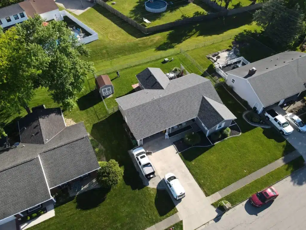 Downward aerial view of composite roof shingles installed on residential home