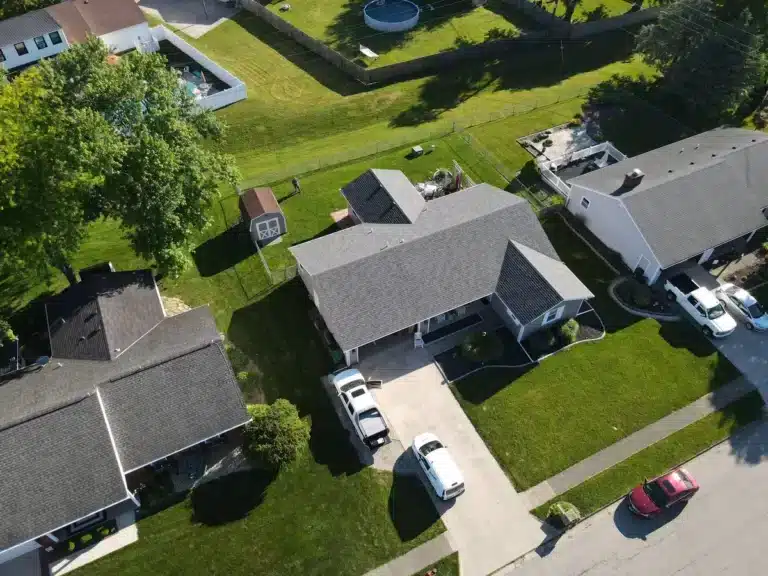 Downward aerial view of composite roof shingles installed on residential home