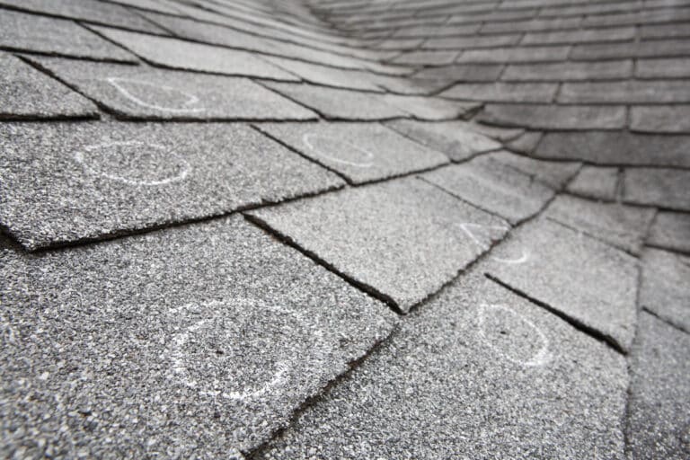 hail damage vs blistering-roof shingles showing where damage has occurred from hail